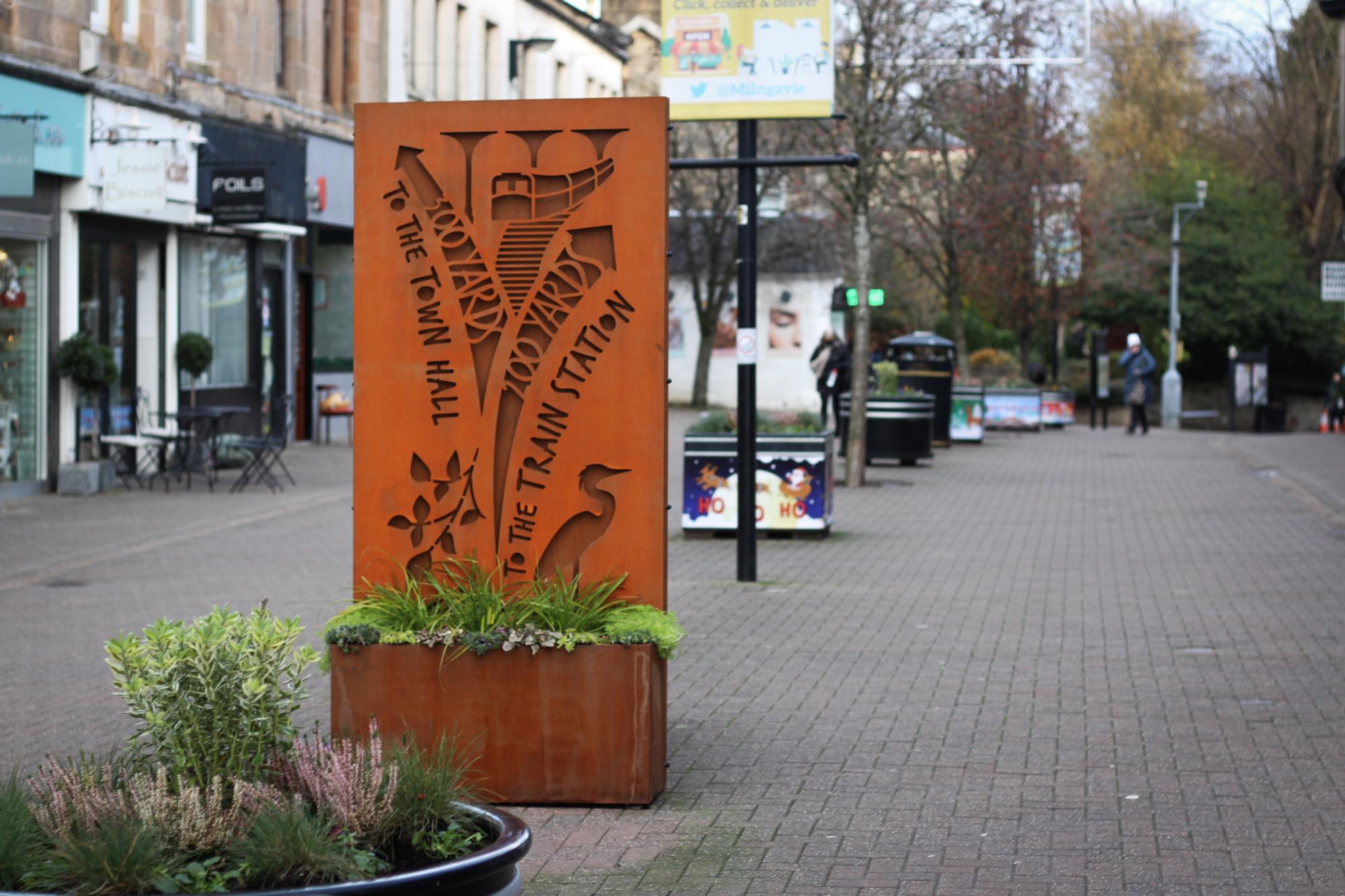 brown sign in the milngavie town centre