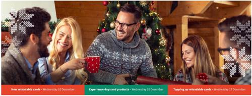 4 people by the Christmas tree having a cup of tea