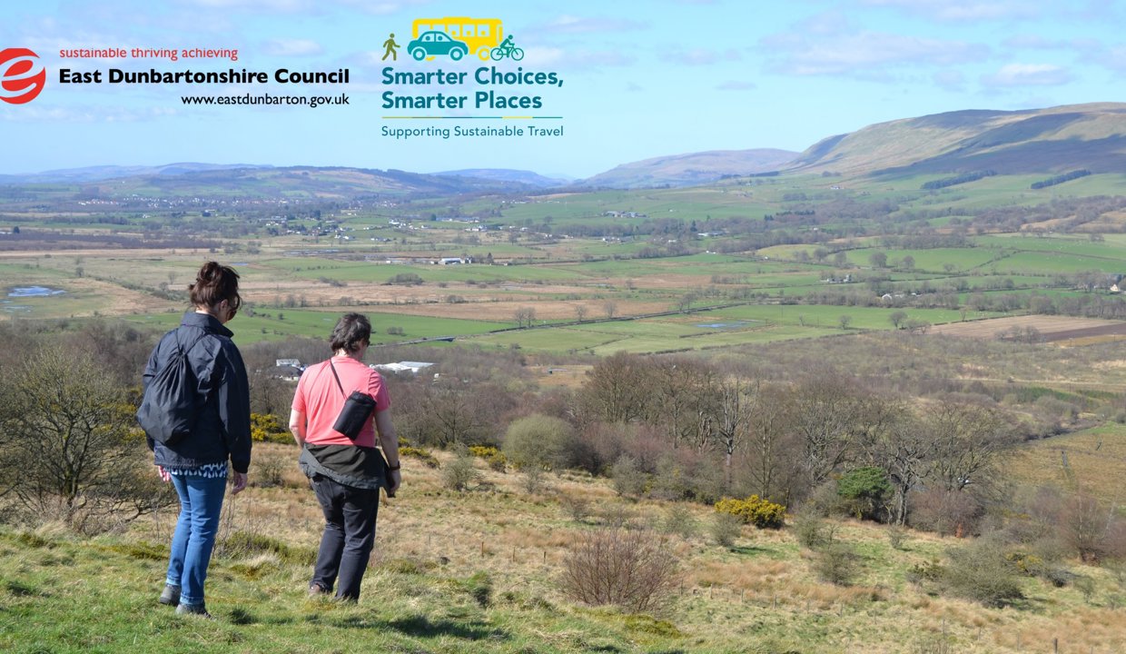 Image of two people walking with Campsies in the background