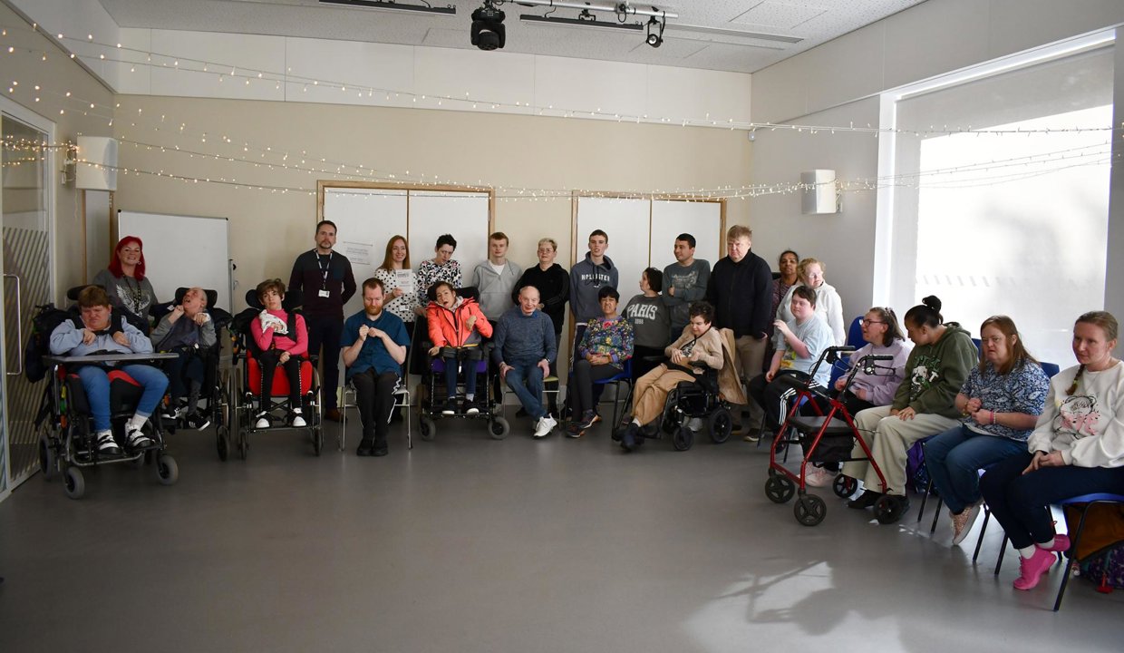 Service users and staff are pictured with the award and representatives of East Dunbartonshire Council, Health and Social Care Partnership, and Leisure and Culture Trust.