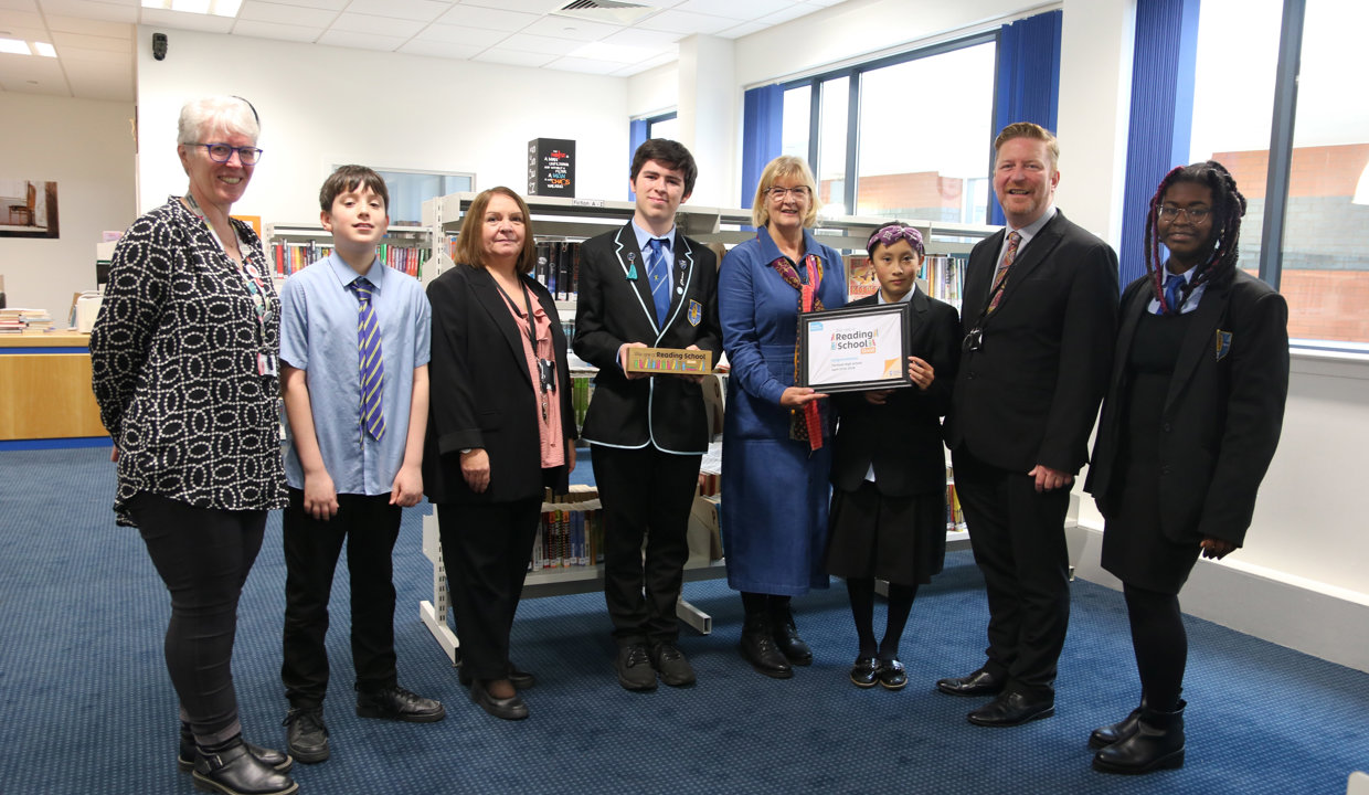 Councillor Williamson holds the reading school award and is pictured with pupils and (left to right): School Librarian Susan Wright, Head Teacher Eileen Kennedy and Greg Bremner.