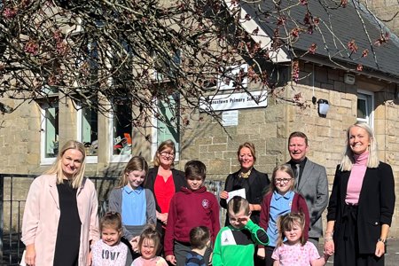 Pupils standing with teachers and Councillor Lynda Williamson outside Lennoxtown Primary School and Early Years Centre 