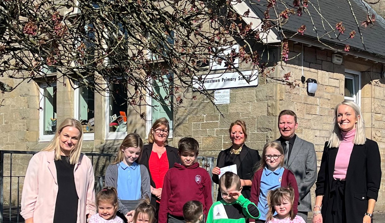 Pupils standing with teachers and Councillor Lynda Williamson outside Lennoxtown Primary School and Early Years Centre