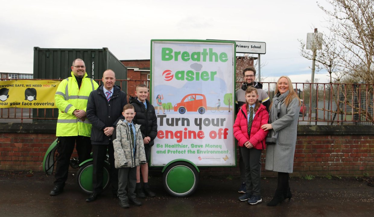 Councillor Paul Ferretti with St Matthew's Primary pupils, standing next to the Breathe Easier adbike