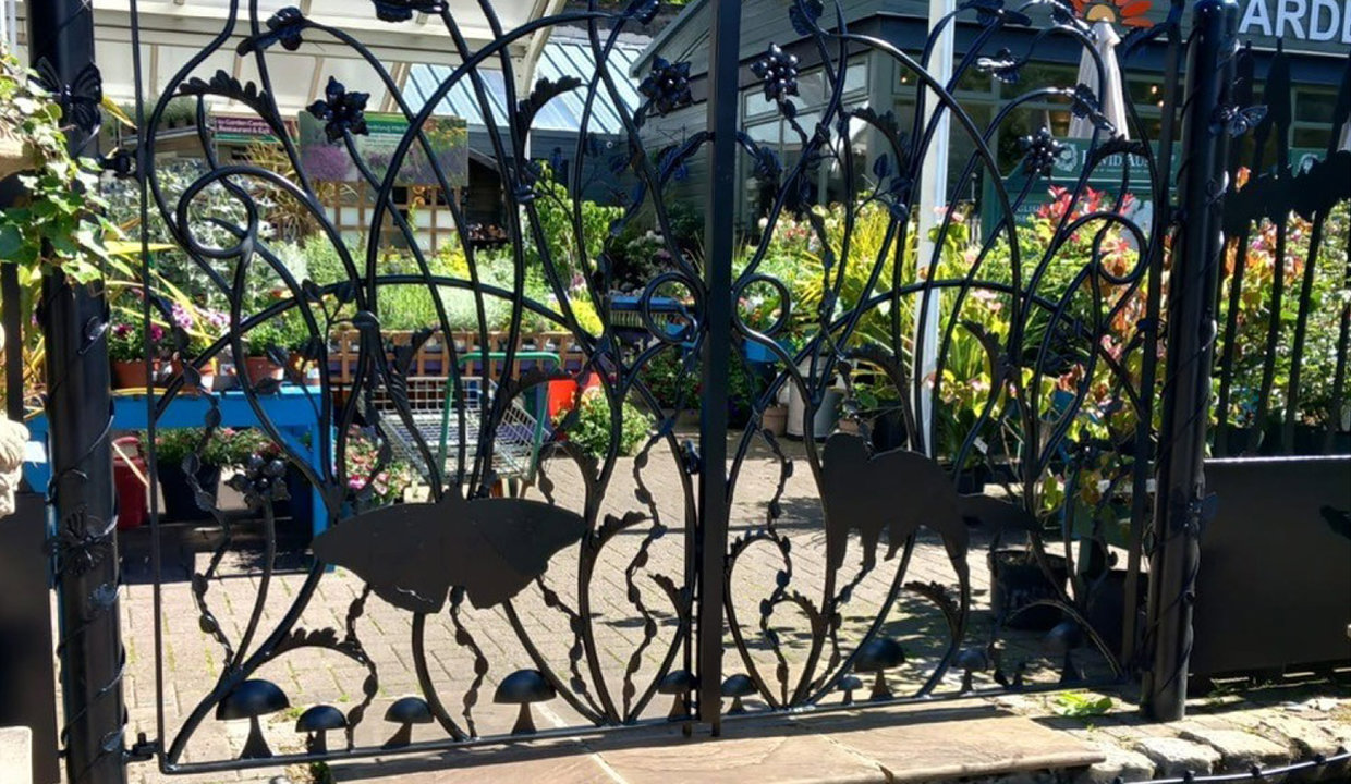 Garden area visible through a black metal fence