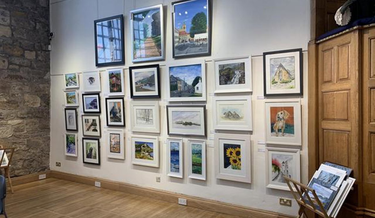 Kelvin Artists exhibition within the Auld Kirk - paintings hanging on wall