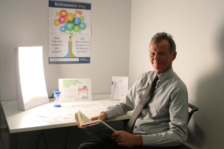 Jim Gibbons sitting in front of sad lamp