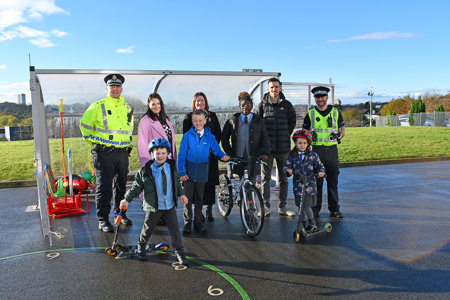 Pupils and teachers are pictured outside one of the schools with police officers and council staff