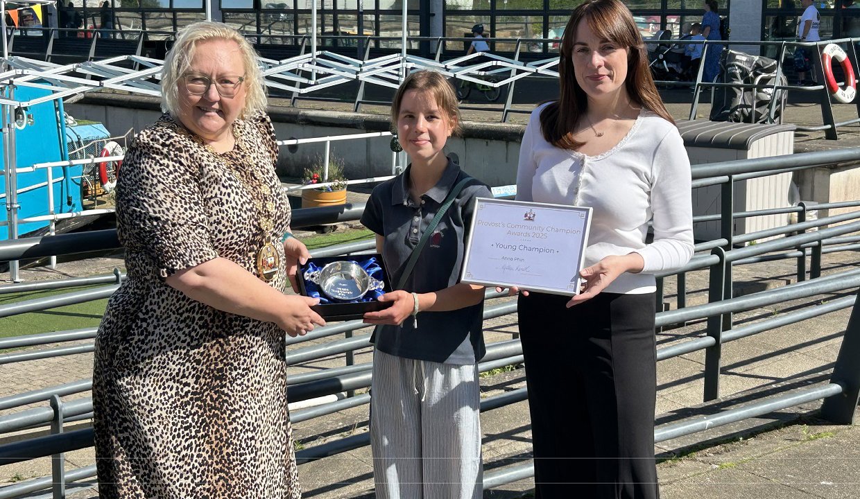 Anna Phin with Provost Renwick (left) and Depute Provost McDiarmid and her award at the Council’s HQ in Kirkintilloch