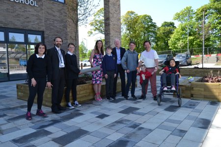 Group shot of pupils, teachers, project manager and Council Leader and Council officer