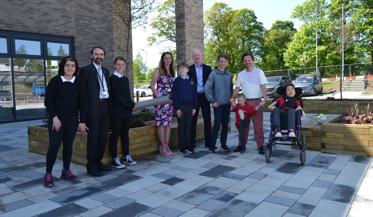 Group shot of pupils, teachers, project manager and Council Leader and Council officer