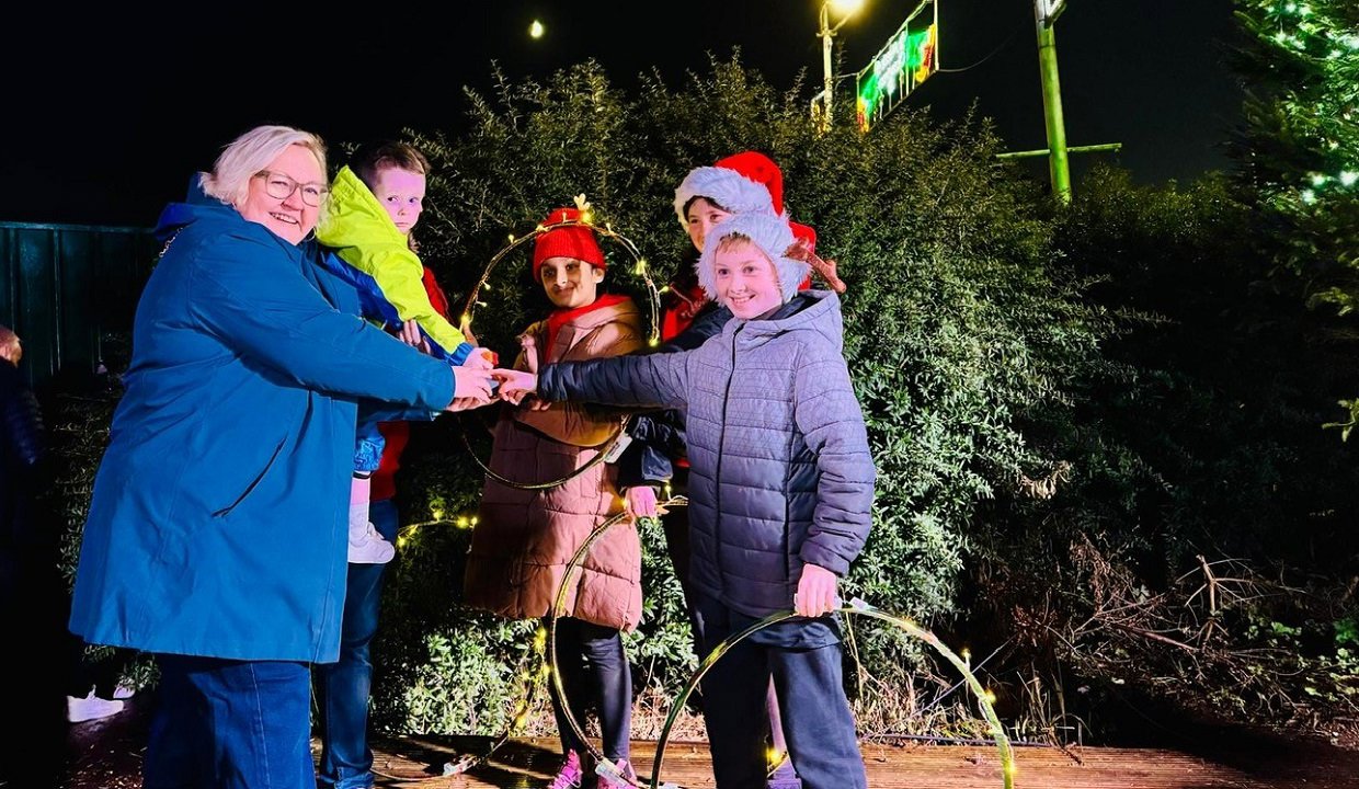 Provost Renwick and helpers push the button to illuminate the tree