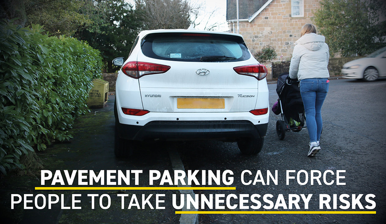 A woman pushing a pram goes onto the road around a car parked on the pavement