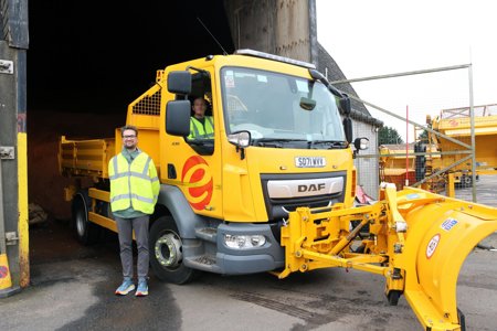 Councillor Paul Ferretti stands to the left hand side of one of the new gritters which are based at Broomhill Depot. In the background is six tonnes of salt inside the massive dome-shaped storage facility.