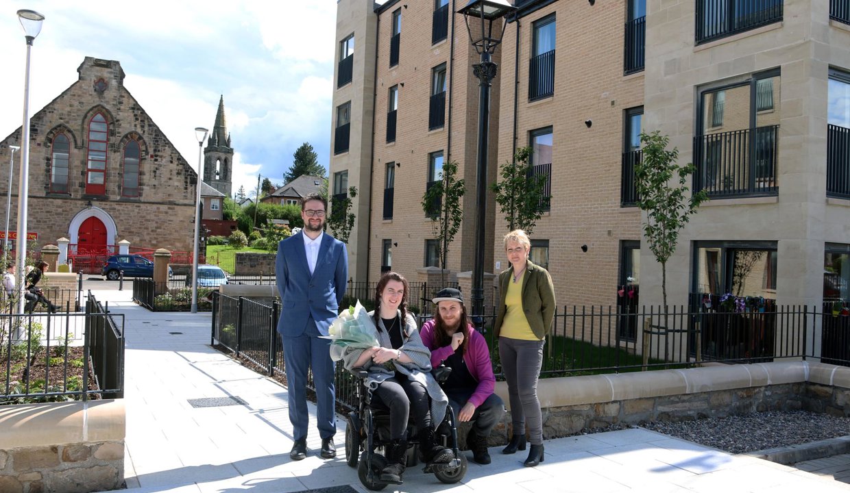 Councillor Paul Ferretti with the first tenants of the new affordable housing on Kerr St, Megan Cassidy and partner Mikey Hanlon