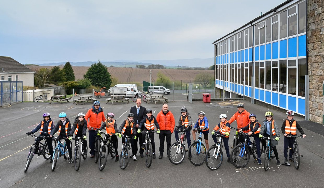 pupils on bicycles outside holy family primary school