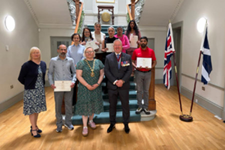 Provost Renwick at Kilmardinny House with new citizens