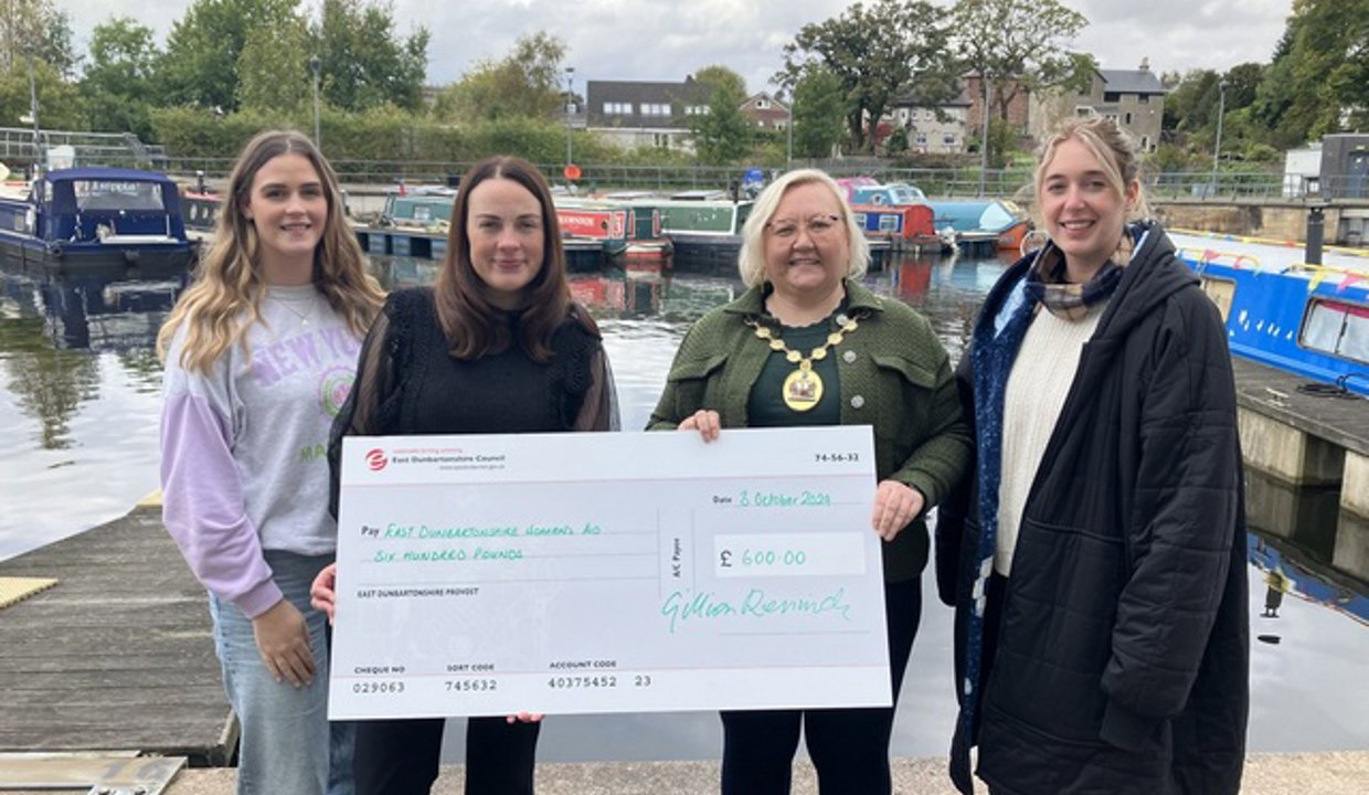 Amy Smith (left) and Sharlene Thurgood (right) from East Dunbartonshire Women’s Aid receiving a cheque for £600 from Depute Provost McDiarmid and Provost Renwick at the marina in Kirkintilloch.