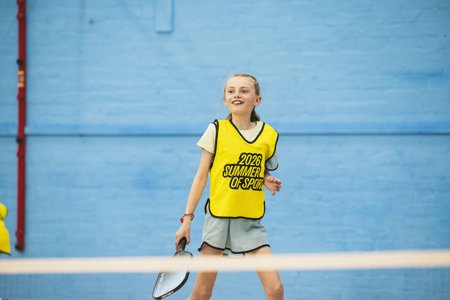 A young girl plays on a sports court