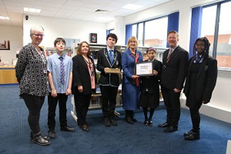 Councillor Williamson holds the reading school award and is pictured with pupils and (left to right): School Librarian Susan Wright, Head Teacher Eileen Kennedy and Greg Bremner.