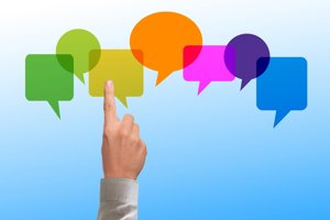 Hand with finger pointing towards speech bubbles