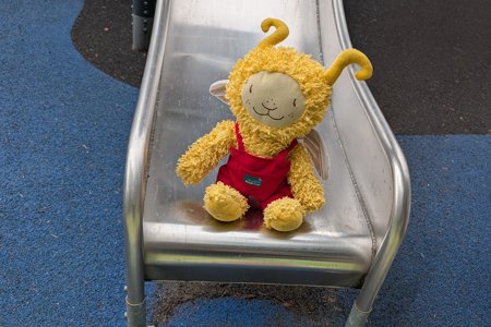 fluffy toy sitting on a metal slide
