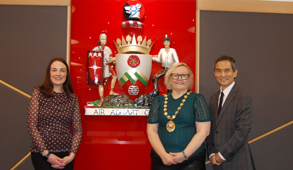 Provost Gillian Renwick and Depute Provost Colette McDiarmid are pictured with Katsutoshi Takeda - the Consul General of Japan in Edinburgh – in front of the East Dunbartonshire crest.