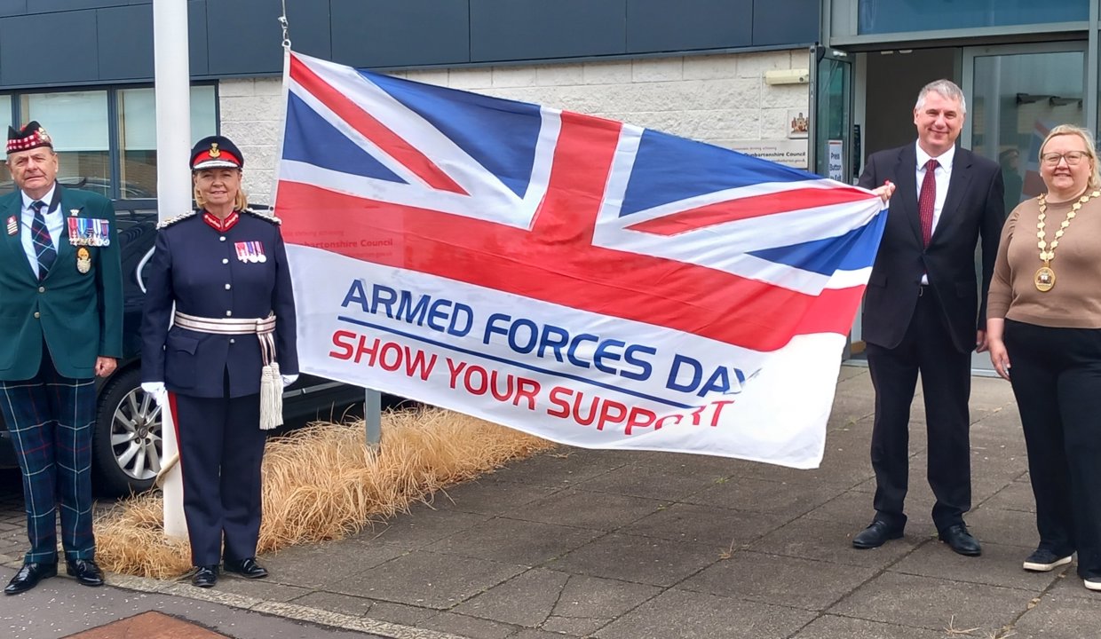 people stand with union jack flag