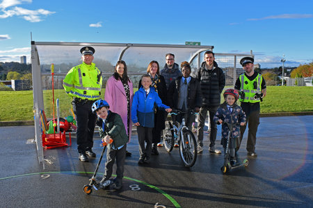 Councilllor Paul Ferretti, Convener of the PNCA committee is flanked by the Headteachers of St Matthew’s Primary School and Wester Cleddens Primary School. Also in pictured are two members of the Community Police team and two pupils from each school posing with scooters and bicycles.
