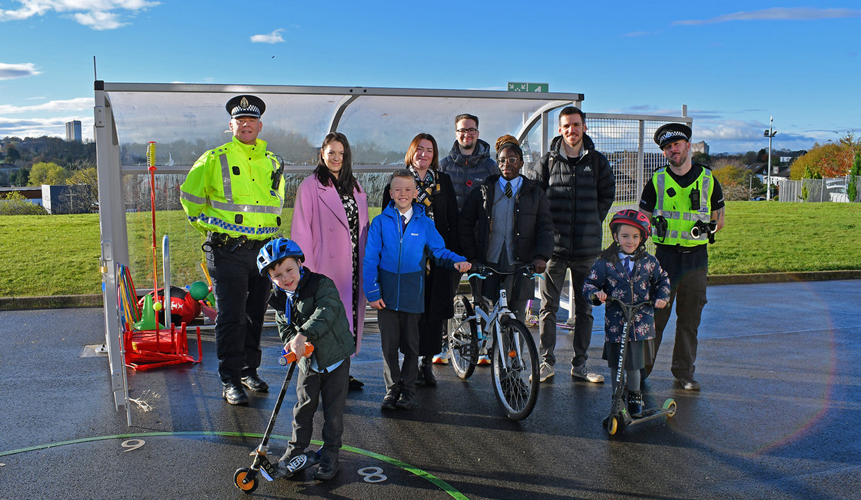 Councilllor Paul Ferretti, Convener of the PNCA committee is flanked by the Headteachers of St Matthew’s Primary School and Wester Cleddens Primary School. Also in pictured are two members of the Community Police team and two pupils from each school posing with scooters and bicycles.