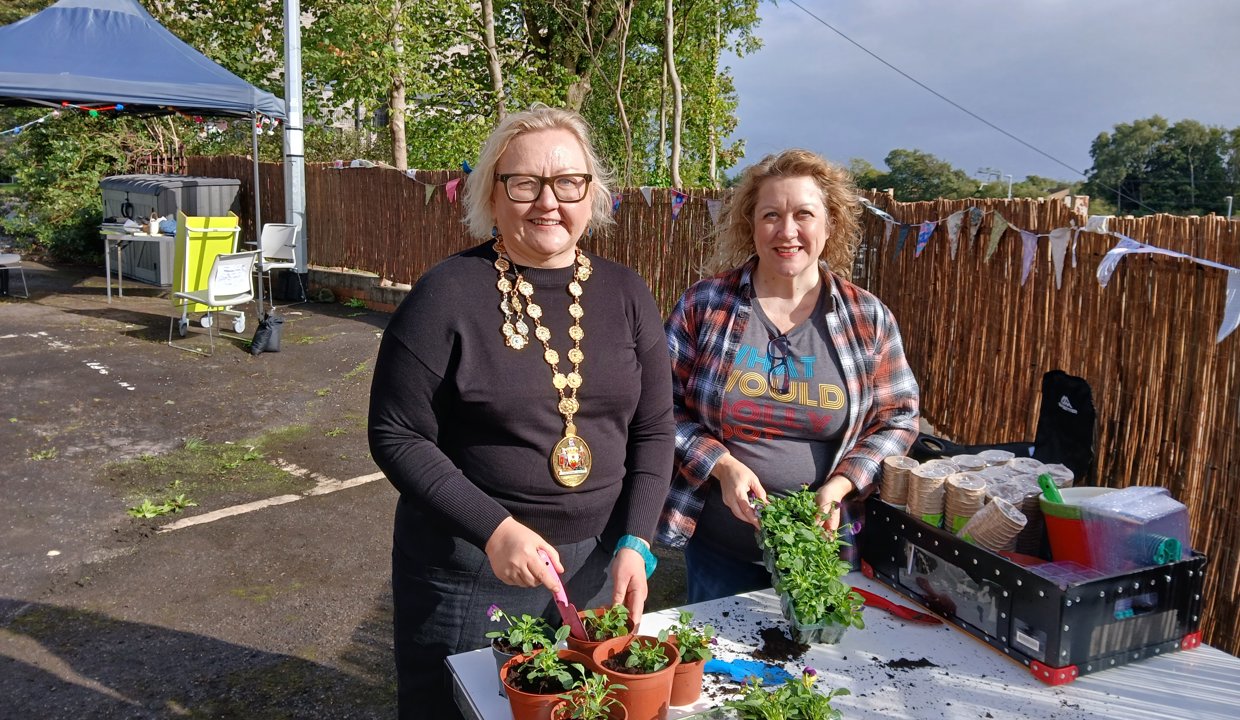 Provost Renwick is pictured potting plants with Brenda Gardiner, Library Service Team Leader.