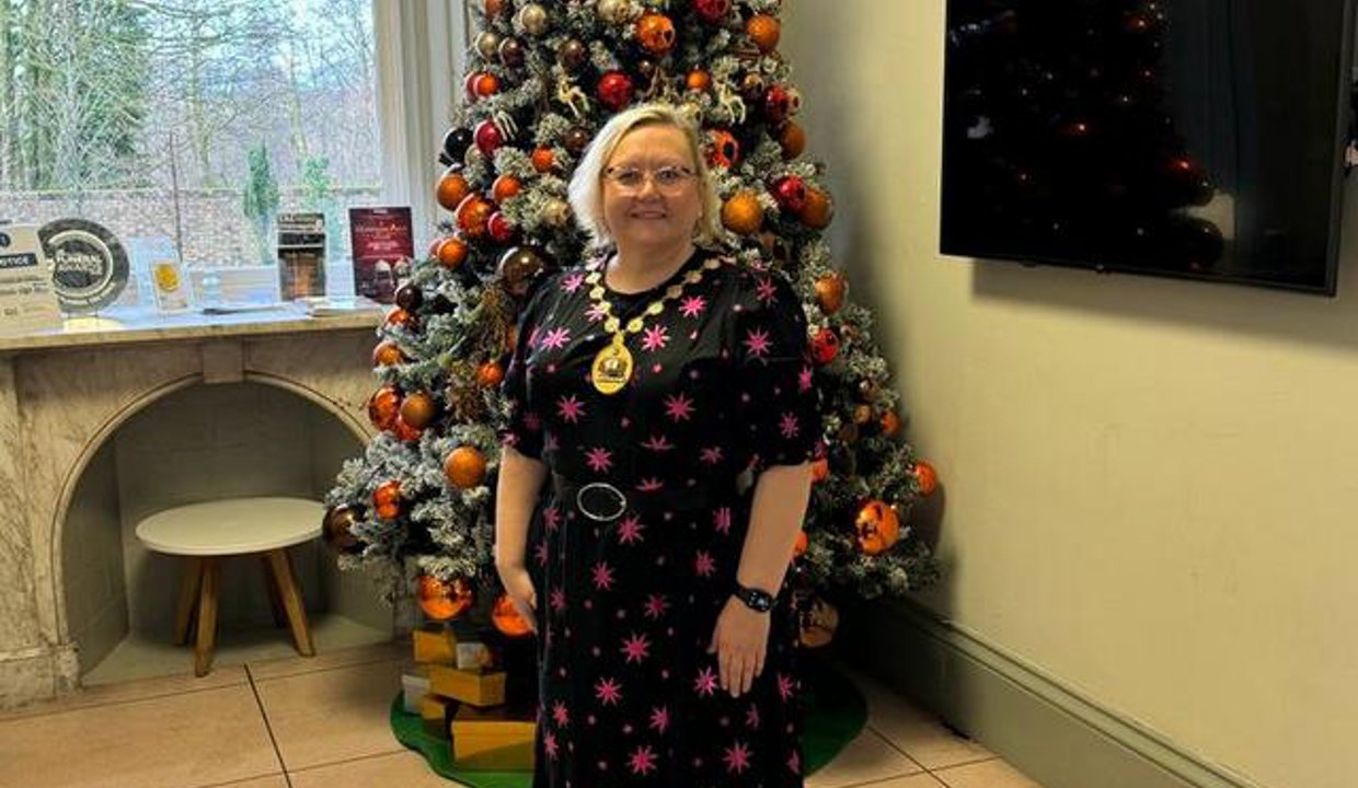 Provost in front of Christmas tree