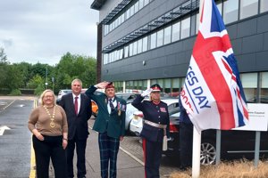 people stand with union jack flag