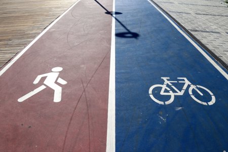 A path with two lanes – one marked for running and one marked for cycling.