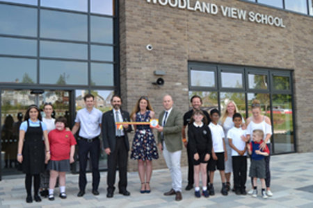 Cllr Gordan Low, HT Kay Hunter and Project Manager of McLaughlin & Harvey, Gary McLeary with staff and pupils of Campsie View and Merkland Schools.