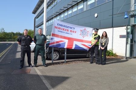 Representative of Fire, Ambulance and Police are pictured with the Depute Provost and the 999 Emergency Services Day flag at the Marina HQ