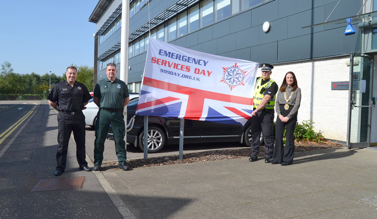 Representative of Fire, Ambulance and Police are pictured with the Depute Provost and the 999 Emergency Services Day flag at the Marina HQ