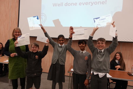 Pupils holding certificates and celebrating winning Euroquiz