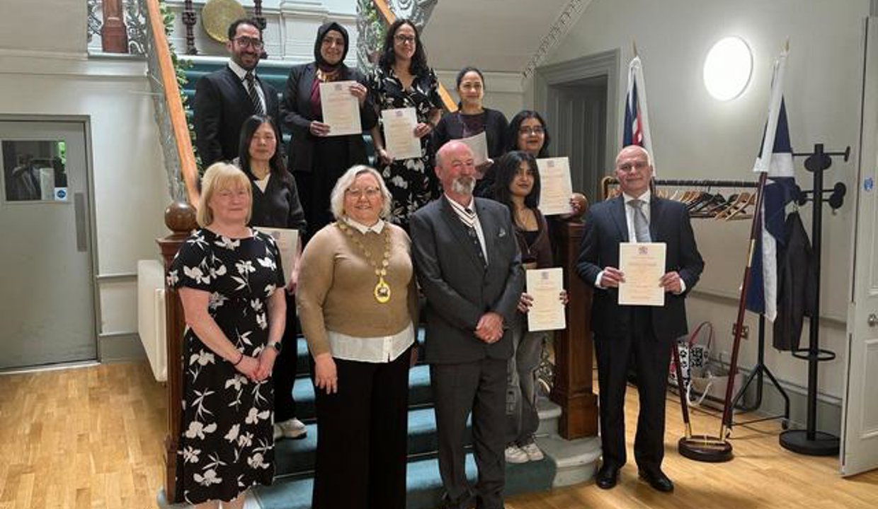 Provost Renwick and Deputy Lieutenant Anne Walker pictured with the new citizens