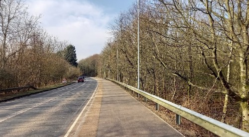 the new active travel corridor running alongside the road with cars travelling along the road