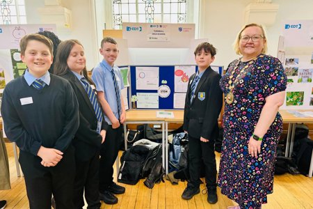 The provost stands with pupils from turnbull infront of their display