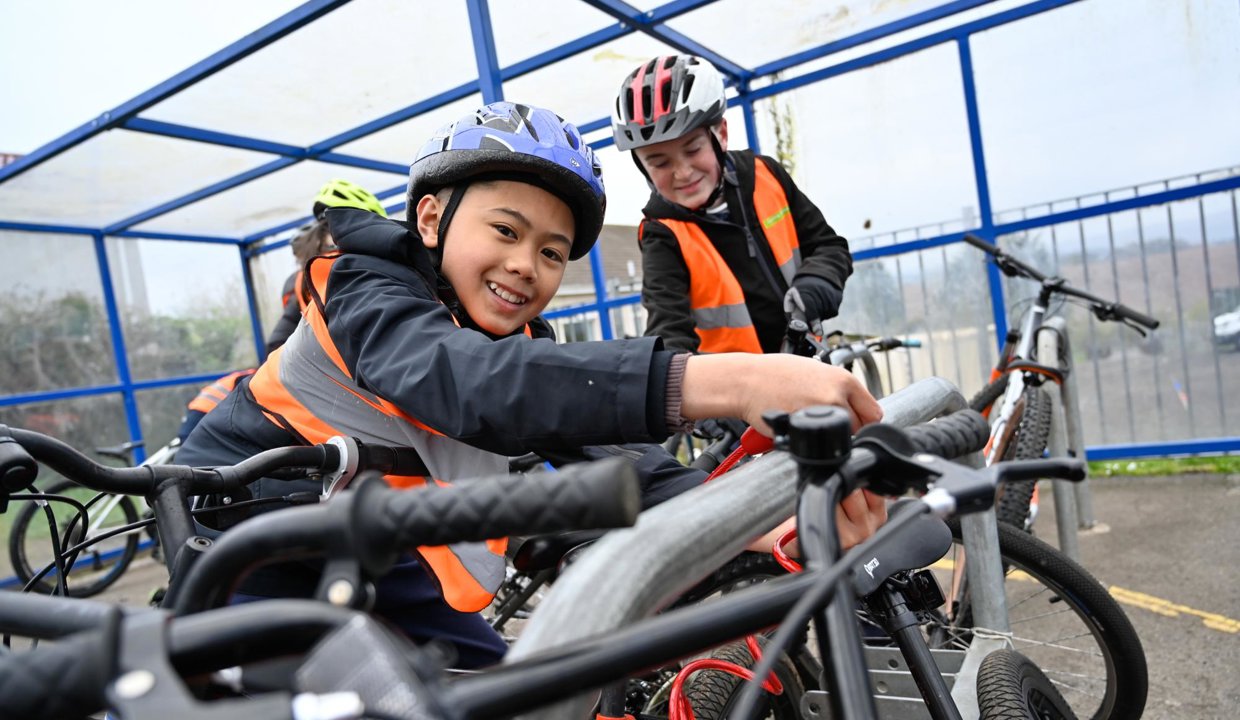 pupils on their bicycles wearing safety equipment