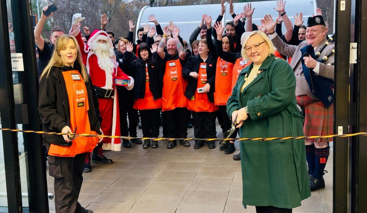 Provost Gillian Renwick and staff cutting the ribbon at the refurbished B&Q store