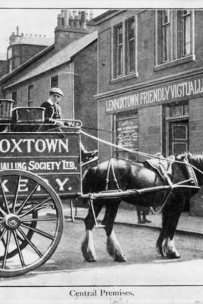 An archive black and white image of a horse and cart in Lennoxtown main street. 