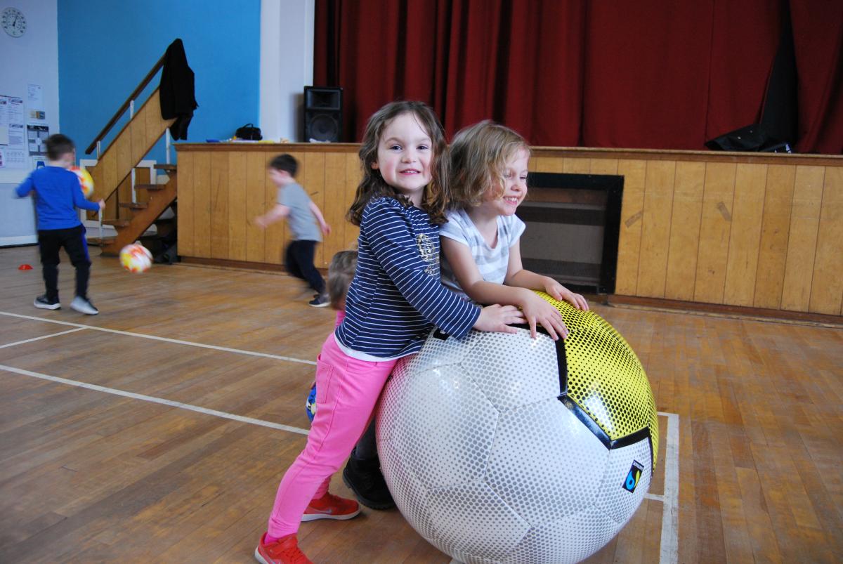 children playing with a large ball
