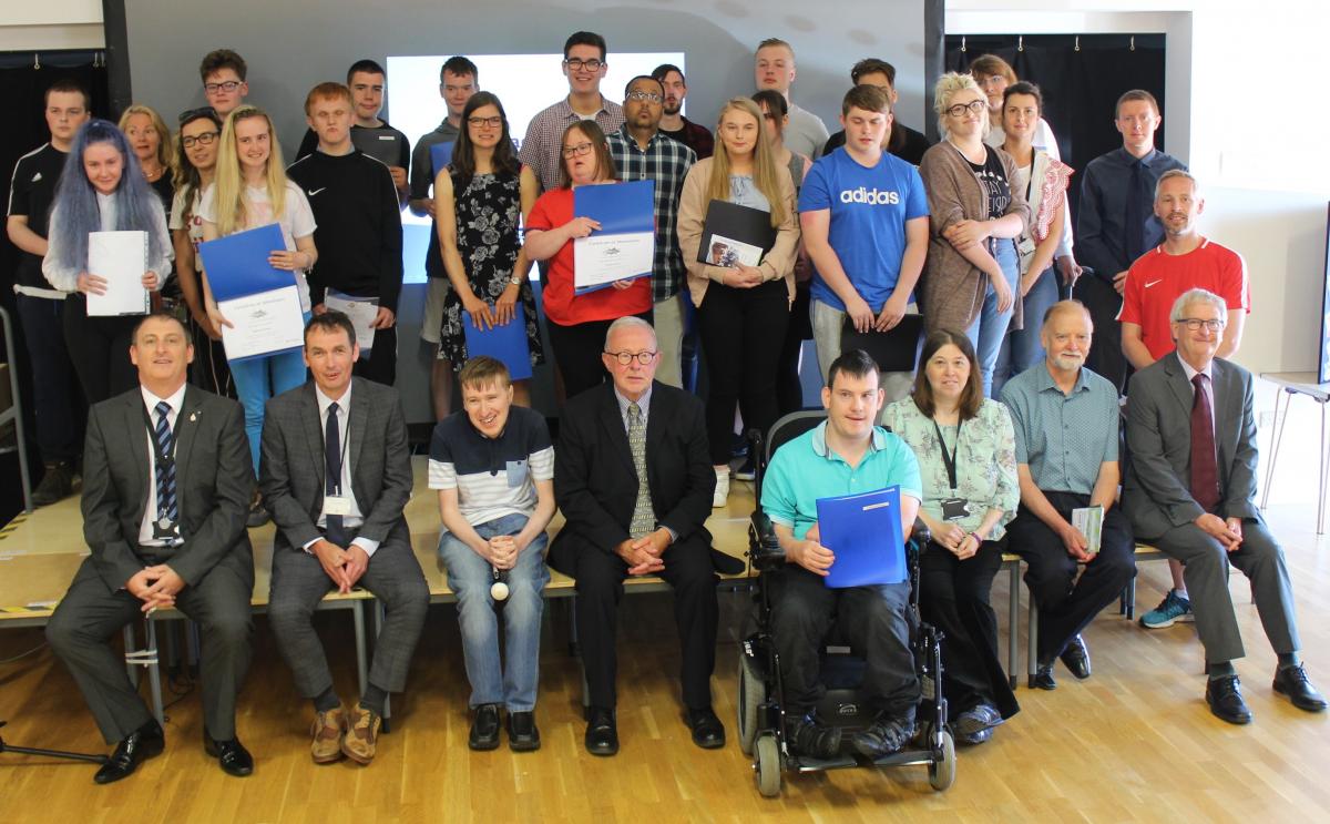 Young people with award certificates