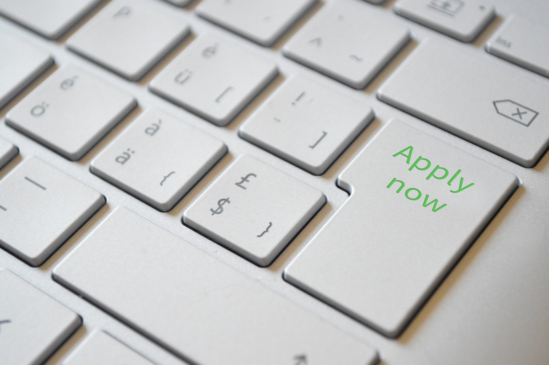Graphic of keyboard with words "apply now"