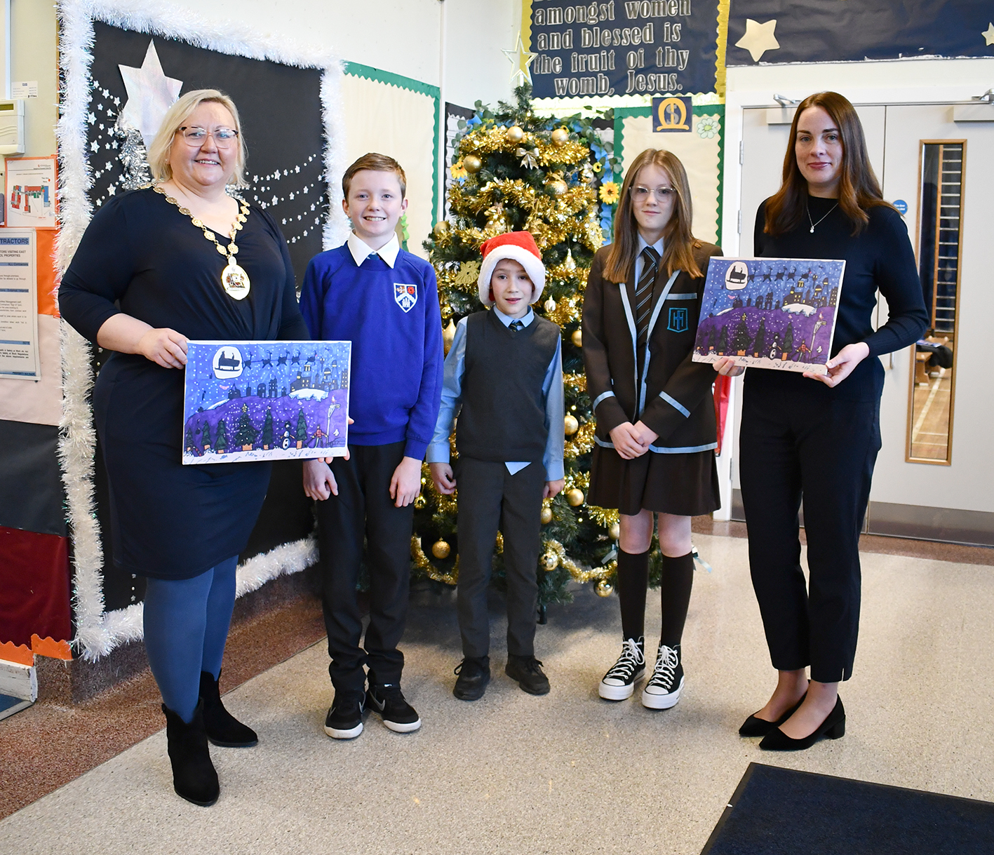 Anthony, Evan and Mya with Provost and Deputy Provost holding his winning Christmas entry