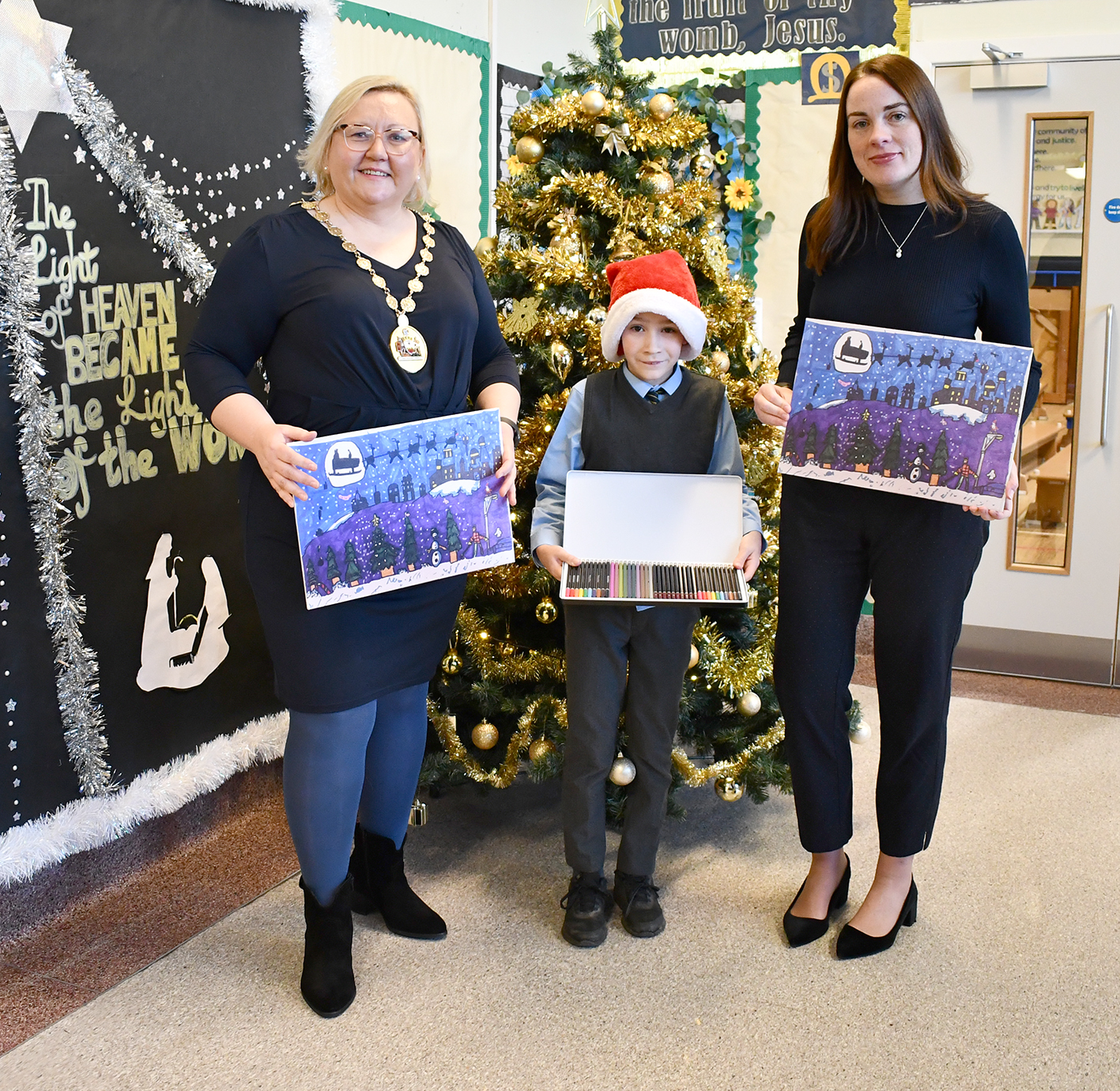 Anthony with Provost and Deputy Provost holding his winning Christmas entry