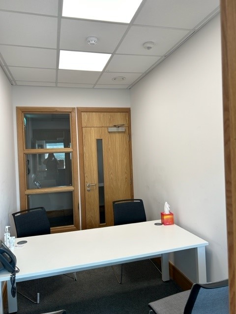Interview room with a white desk and chairs